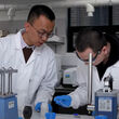 Lead author Tianyi Ma working with assistant on water batteries.