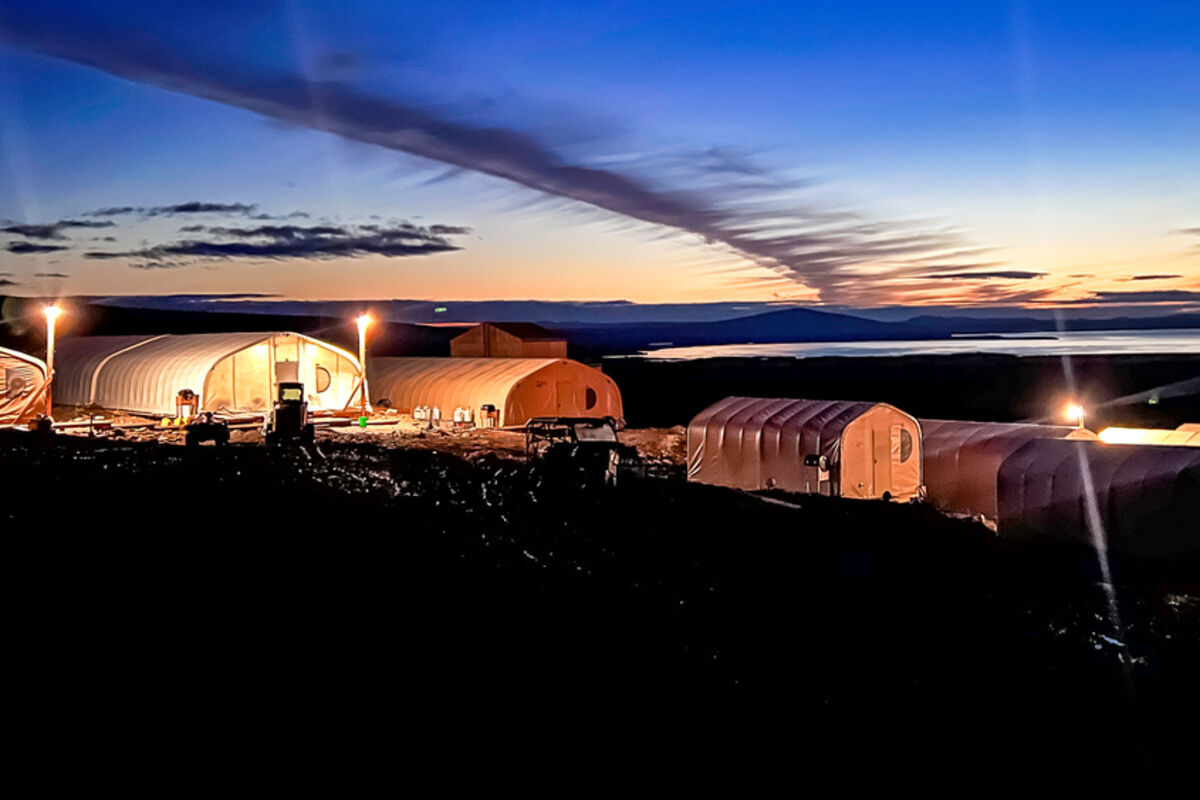 A%20colorful%20sunset%20behind%20commercial%20Quonset%20tents%20at%20graphite%20project%20in%20Alaska%2E