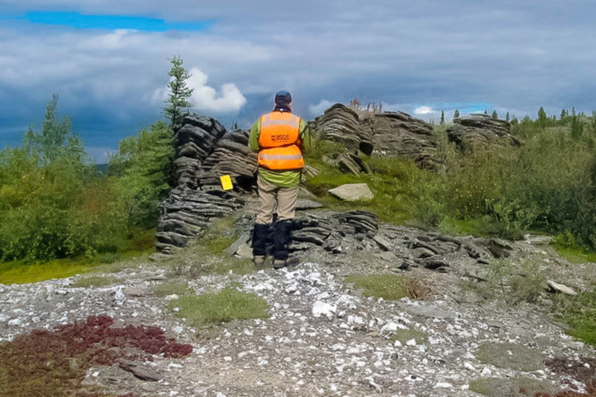 A%20USGS%20geologist%20collecting%20samples%20from%20an%20outcrop%20of%20rocks%20in%20Alaska%2E