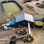Aerial view of a small gold recovery plant and water storage pond at 3 Aces.