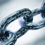Chain links with binary code representing digital security.
