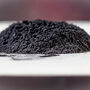A pile of black powder produced during the lithium battery recycling process.