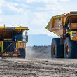 Cat is developing electric versions of large mining haul trucks like these.