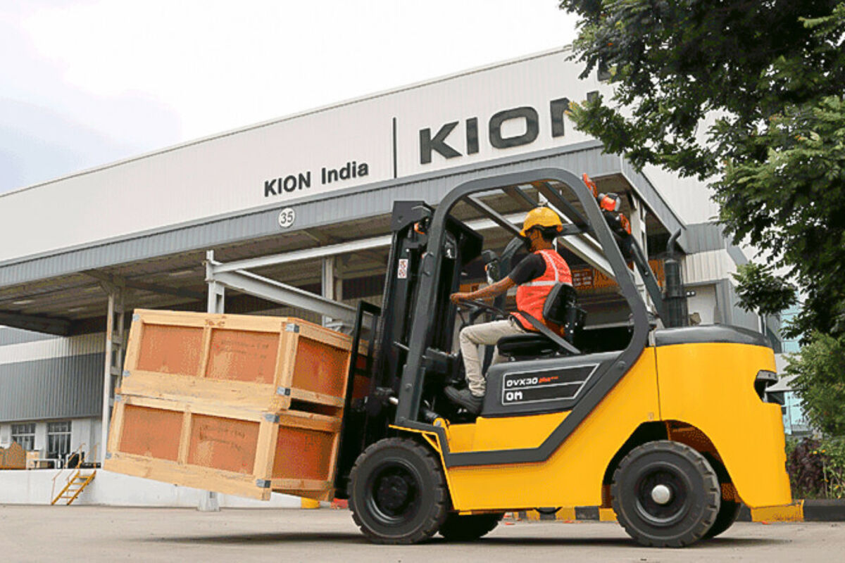Employee operating a KION forklift in India.