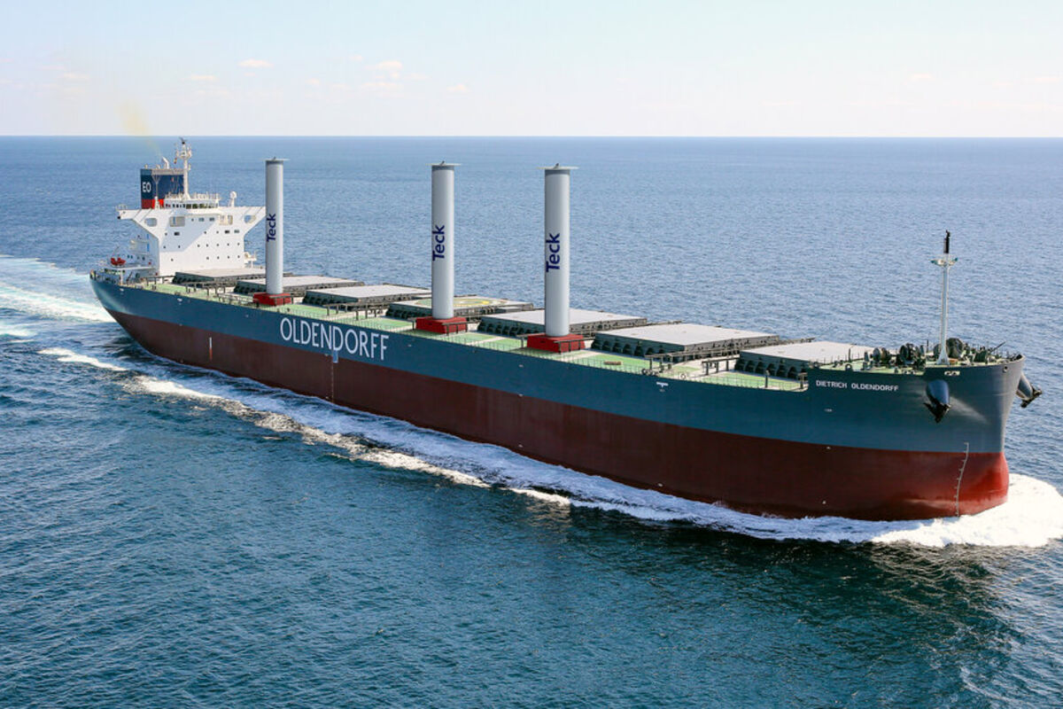 A bulk commodities ship equipped with large white cylinders with Teck logo.