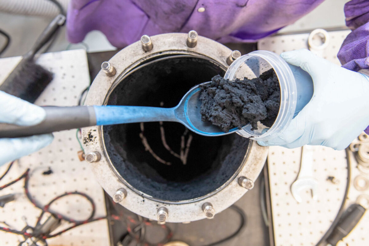 Kansas State University scooping graphene out of a small detonation chamber.