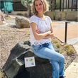 University of Texas Research scientist Estibalitz Ukar sitting on a rock.