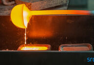 Molten rare earth metal being poured into ingot molds.