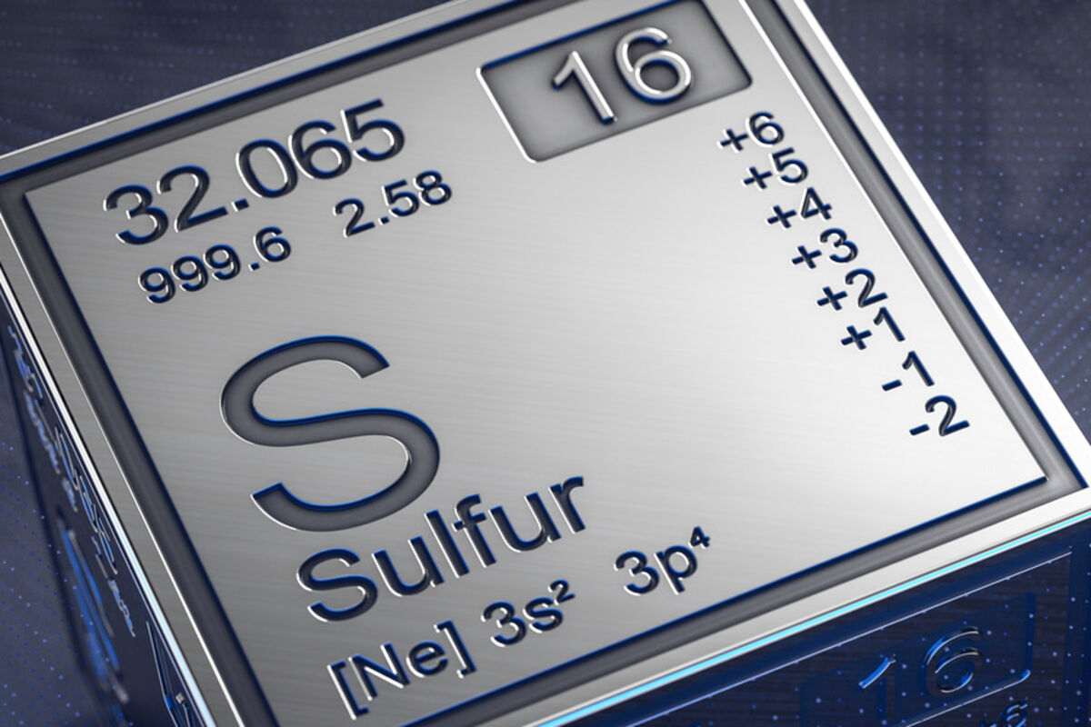 A metallic cube of sulfur’s symbol on the periodic table of elements.