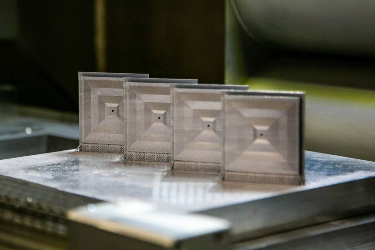 A row of square S-band antenna (RF) patches created on a metal 3D printer.