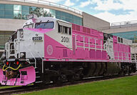 A Wabtec battery-electric motor painted pink for breast cancer awareness.