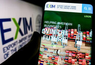 A smartphone displaying the EXIM website homepage.