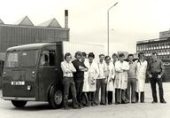 The original Beta Research team posing for picture in from of truck.