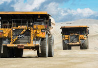 Two Cat 793 trucks haul equipped with BreadCrumbs haul ore at Fort Knox Mine.
