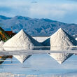 Piles of white lithium reflect off the water at mining operation in Argentina.