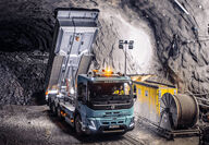 A Volvo FH Electric truck dumping rocks inside an underground mine.