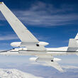 A NASA high-altitude plane in flight over snow-covered mountains.