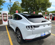 Ford Mach-E electric vehicle parked at a Tesla Supercharger.