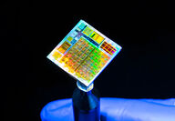 A KAUST researcher displays first 2D microchip with multicolored surface.