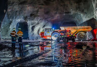 A photo of a Sandvik underground haul truck deep inside a tunnel.