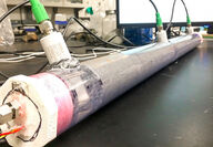 Tube filled with reactive tailings material being injected with CO2 exhaust.