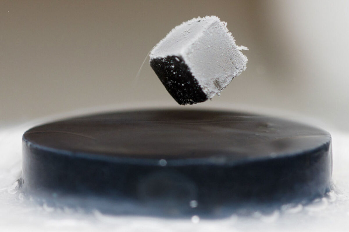 A magnet levitates above a liquid nitrogen-cooled superconductor.