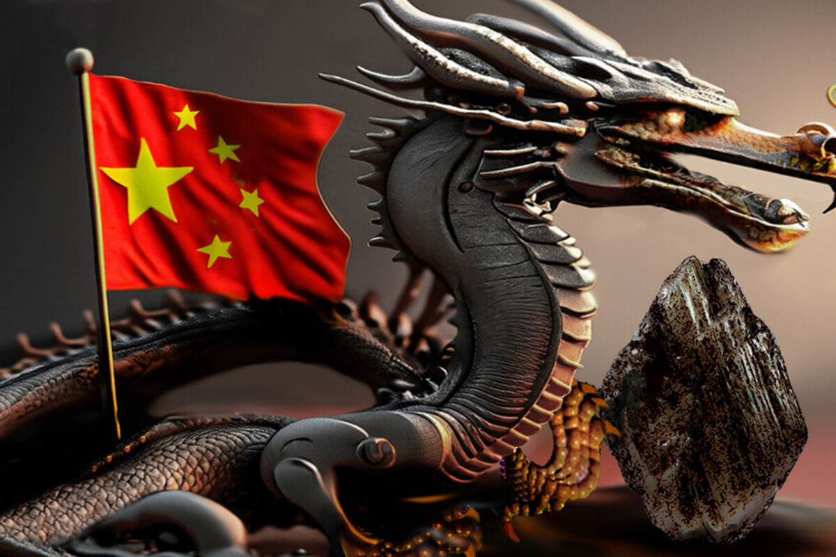 A metallic dragon with its claws on a graphite stone and the Chinese flag.