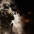 A U.S. special forces soldier in a billow of smoke during a night patrol.