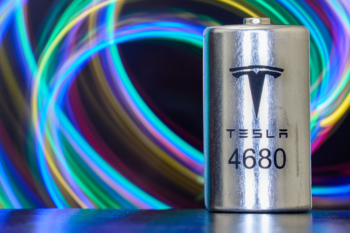 A Tesla 4680 lithium-ion cell for EVs against a background of colorful swirls.
