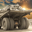 A large truck hauling a load of rocks at a mining operation.
