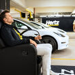 Hertz Tesla Tom Brady EV electric vehicle rental charging stations US 100,000