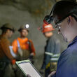 An underground miner checks an electronic tablet at Hecla’s Greens Creek Mine.