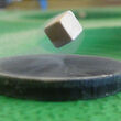 A floating metallic cube above a supercooled superconductor, quantum locking.