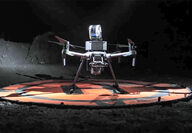 An ExynAero drone on a landing pad underground.