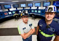 Two CONSOL Energy employees standing in an operations room.