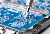 Tin solder is being used to repair a computer microcircuit.