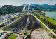 Looking over long stockpiles of coal toward a power plant in Slovenia.