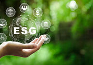 A hand holding the graphics of ESG and its various positive influences.