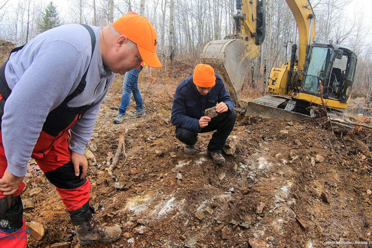 Crew inspects the ground for mineralization at MacDonald Mines SPJ Gold project.
