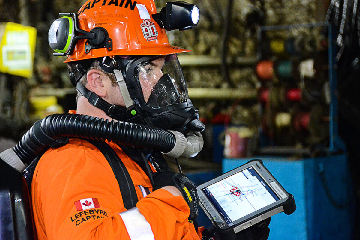 Ontario Mine Rescue captain with safety gear and digital tablet.