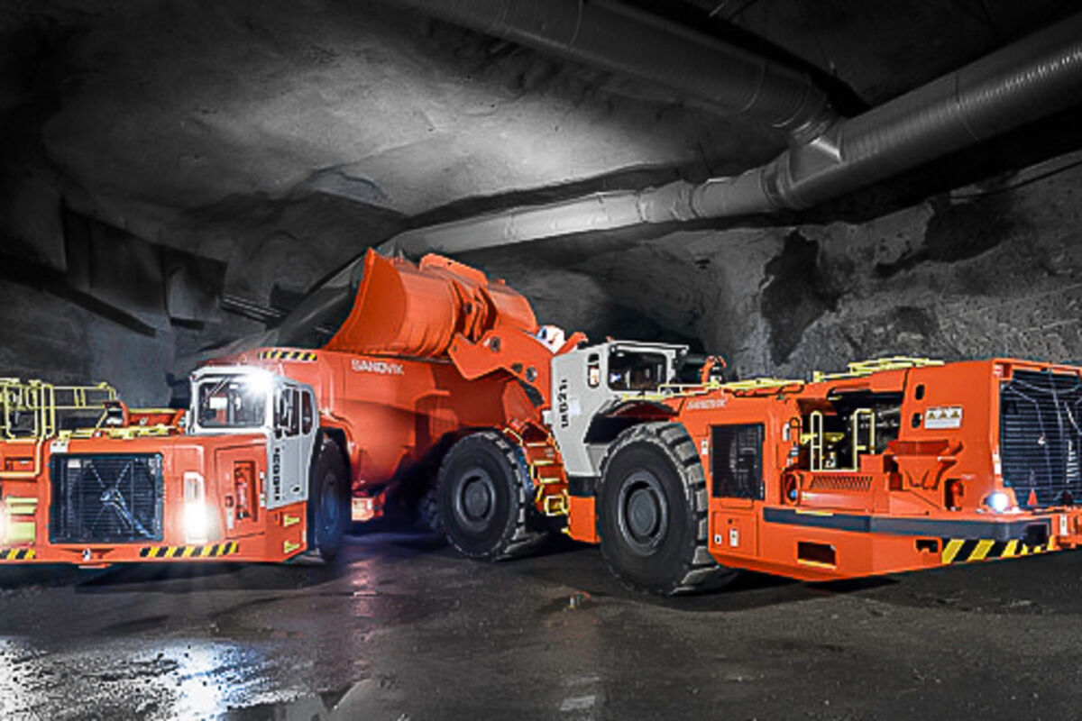 A battery-electric Sandvik truck and loader working underground.
