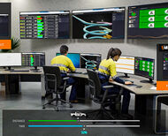 Workers monitor underground mine operations from high-tech office on surface.