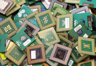 A bin full of retired CPUs from old laptops or computers.