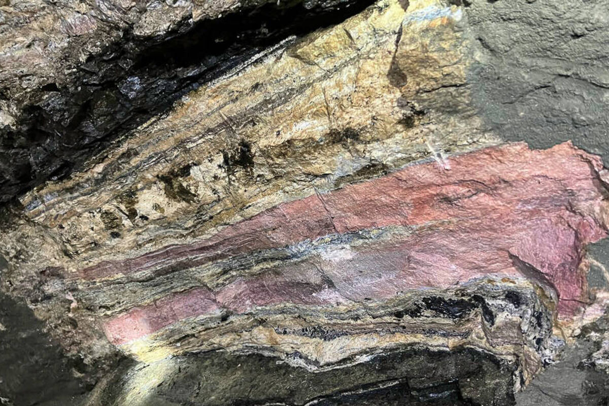 Bands of cream-colored carbonatite and pink ancylite underground at Sheep Creek.