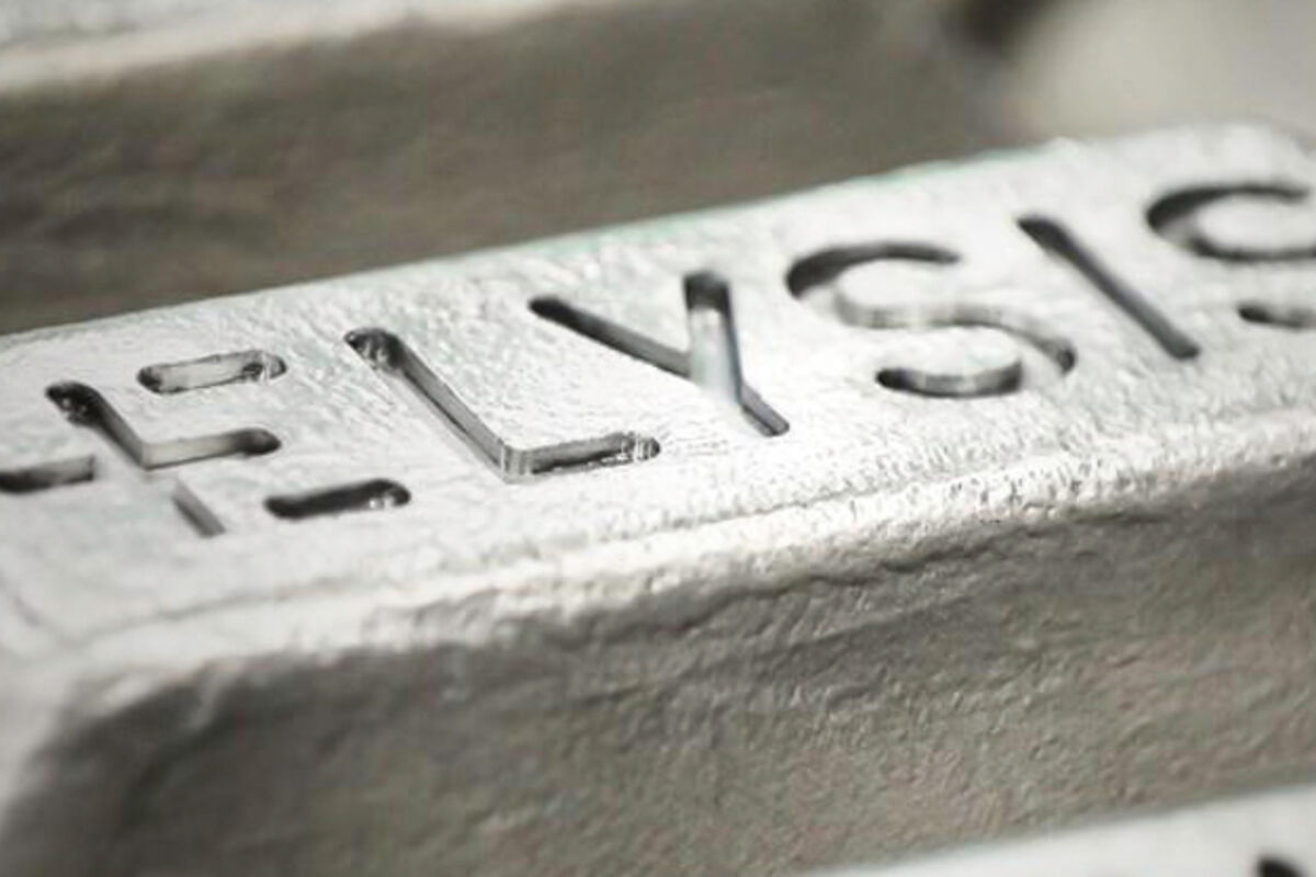 Closeup of an aluminum bar stamped with ELYSIS.