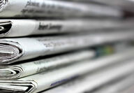Closeup of a stack of newspapers.