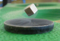 A floating metallic cube above a supercooled superconductor, quantum locking.
