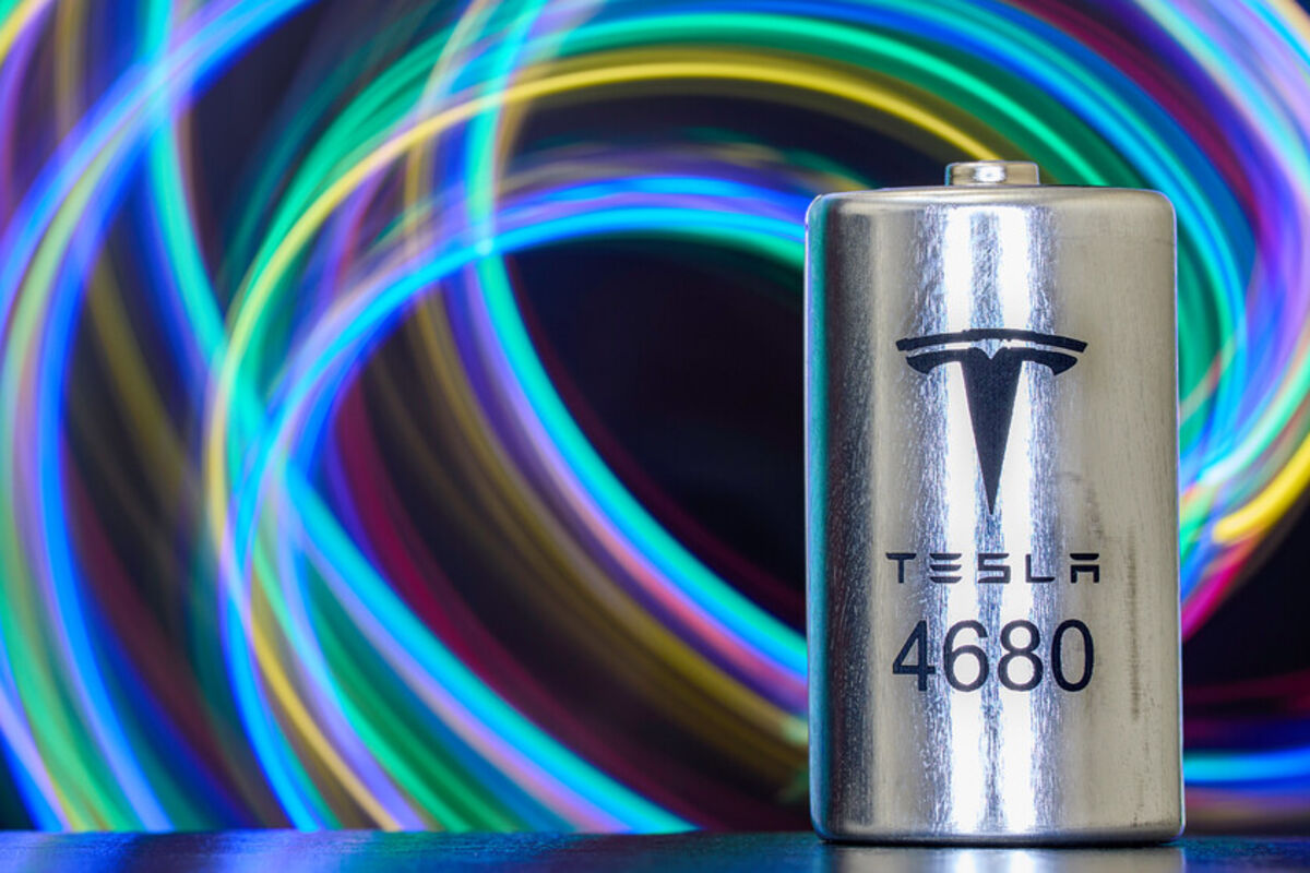 A%20Tesla%204860%20lithium%2Dion%20battery%20with%20a%20backdrop%20of%20brightly%20colored%20swirls%2E