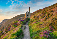 A rock pump house and smoke stack on the picturesque Cornish coast.