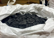 A large canvas sack filled with lumps of recycled batteries or black mass.